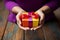 A womans hands hold a gift box