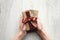 Womans hands holding gift box wrapped festive ribbon and label with text Happy Father`s Day on wooden table, top view. Present fo