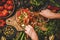 Womans hands mixing Turkish Chopard Salad with vegetables, herbs, spices