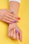 Womans hands with summer colors nails.