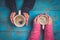 womans holding hot cup of tea on wooden background