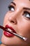 Womans lips holding make up brush