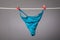 Womans panties on laundry rope attachd with pegs with red heatrs