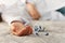 Womanâ€™s hand close up committing suicide by overdosing on medication, pills and bottle beside. Overdose pills and addict concept