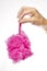 Womanâ€™s Hand Dangling Pink Bathroom Loofah Isolated On White