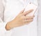 Womanâ€™s hand with diamond ring holding cellphone