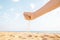 Womanâ€™s hand pours sand outdoor.