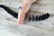 Womanâ€™s hand stopping domino effect on wooden table, aerial or top view