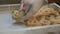 A womanâ€™s hands putting uncooked spaghetti or tagliatelle into plastic tray. Making noodles. Lots of uncooked Italian pasta