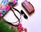 Women accessories summer holiday season handbag sunglass wallet colorful red green lilac background