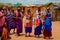 women from the African tribe Maasai in national dress in their village houses made of clay