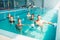 Women aqua aerobics traninig with dumbbells