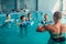 Women aqua aerobics traninig with dumbbells