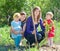 Women and baby girls planting raspberry