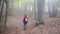 Women with backpack walking in the forest at springtime, slow motion footage