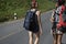 Women Backpacker Walking along The Street Side