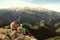 Women backpackers enjoy the view on mountain peak cliff