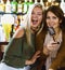 Women in bar singing karaoke