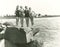 Women in bathing suits posing on rock