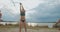 Women beach volleyball in slow motion shot, young women are playing with ball on shore at summer, training of