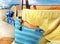 women beachwear  on wooden bench  hat with blue bow and hand bag and yellow towel  accessory, on horizon sea wave spl