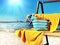 Women beachwear  on wooden bench  hat with blue bow and hand bag and yellow towel  accessory, on horizon sea wave spl