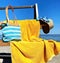 Women beachwear  on wooden bench  hat with blue bow and hand bag and yellow towel  accessory, on horizon sea wave spl