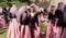 Women in beautiful Georgian dresses talking in crowd of people during popular wine festival