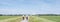 Women on bicycle and spring flowers near area with wind turbines in dutch province of flevoland