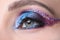 Women bright multi-colored evening eye makeup closeup