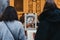 Women browse retro posters at second hand book market in the courtyard of the Vieille Bourse old stock exchange in Lille, France.