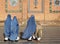 Women in burqas in front of the Great Mosque of Herat in Afghanistan