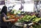 Women buying vegetables in wet market. women picking varieties of vegetables from retail stalls in the traditional market.