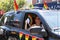Women in car with rainbow clor fan during Gay Pide Car Parade
