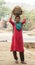 Women carry manure from Govardhan Hill in India