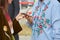 Women checking samrtphone with floral embroidery shirts before Gucci fashion show, Milan Fashion Week street