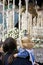 Women with a child in his arms costalero clothing in a procession of holy week