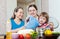 Women with child together cooking veggie lunch