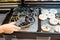 Women choosing donut at the supermarket. bun tongs and tray