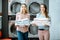 Women with clean clothes in the laundry
