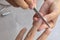 Women clean the fingernail for the customer with a nail file