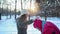 Women cleaning snow they covered with from coats in winter forest and laughing. Family having fun outdoors.