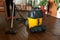 Women cleaning the wooden floor with industrial vacuum cleaner