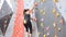 Women climbing on a wall in an outdoor climbing center.