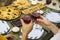 Women clink glasses of wine at a brunch table of pastries.