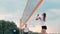 Women Competing in a Professional Beach Volleyball Tournament. A defender attempts to stop a shot during the 2 women