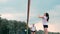 Women competing in a professional beach volleyball tournament. A defender attempts to stop a shot during the 2 women