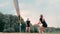 Women Competing in a Professional Beach Volleyball Tournament. A defender attempts to stop a shot during the 2 women