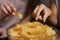 women couch watching tv eating chips close up. High quality photo