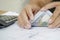 Women counting dollar bills, finances and accounts